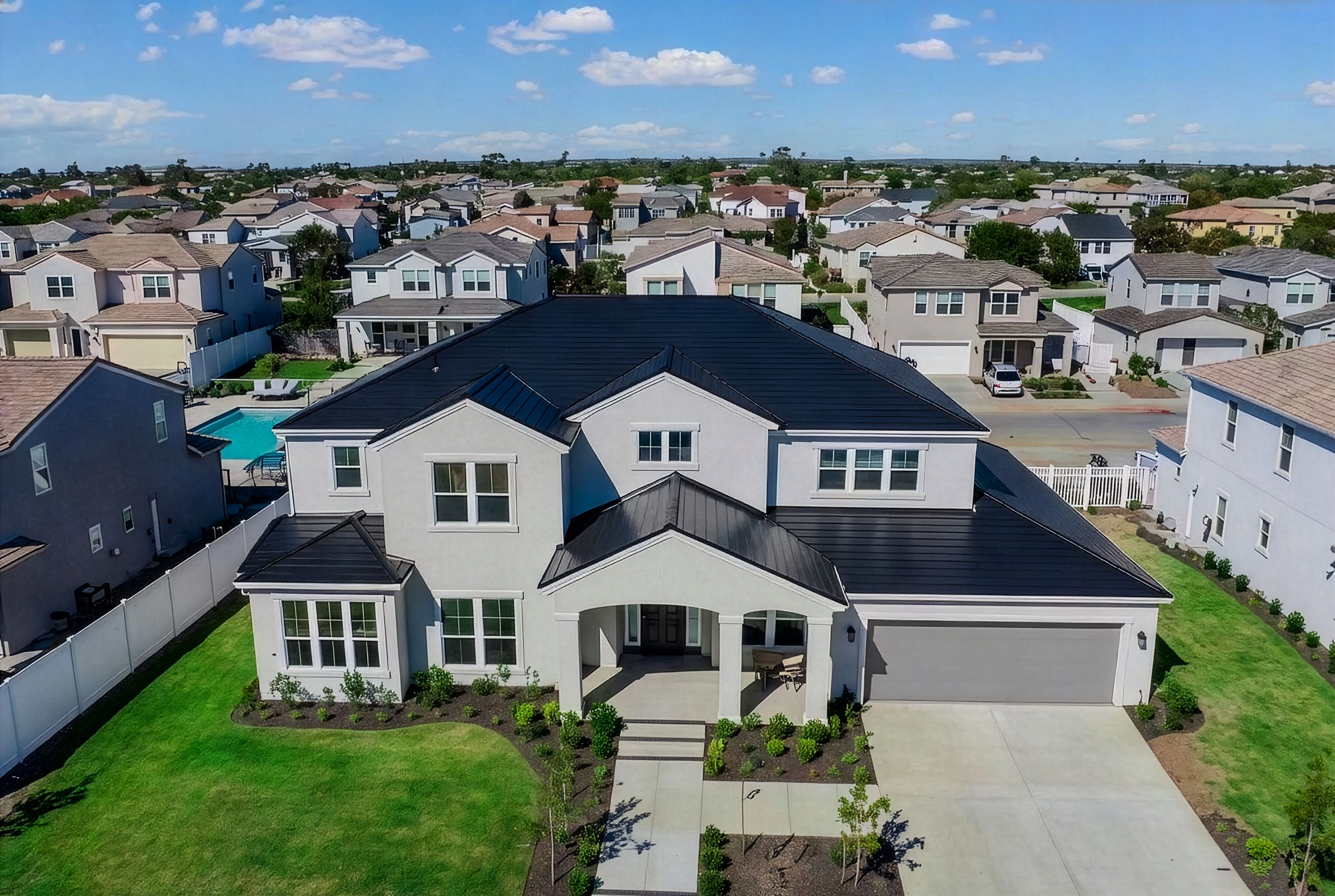 Aerial drone photo of a new-construction two-story home in a community