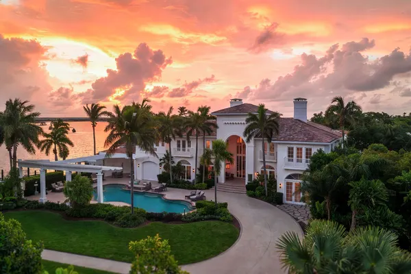 Luxury waterfront estate at fiery sunset with pool, Orlando FL
