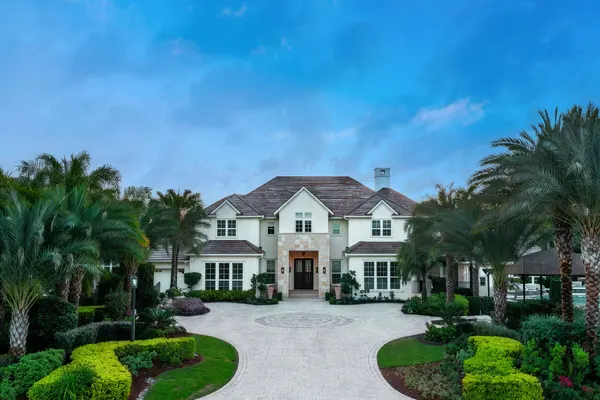 Grand luxury estate entrance with circular drive at twilight, Orlando FL