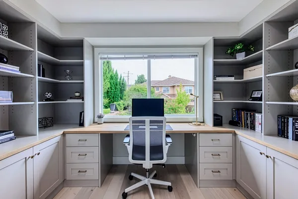 Home office with custom built-in L-desk, shelving and garden window